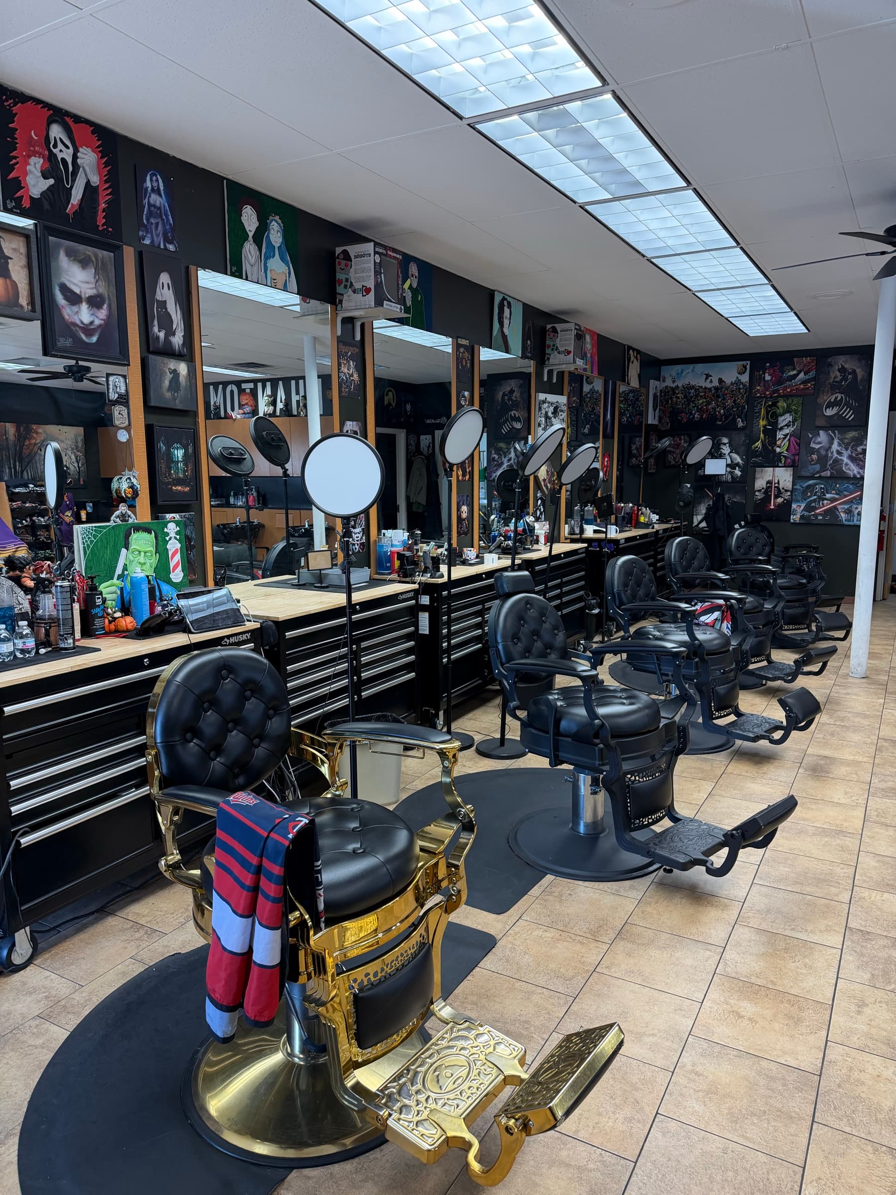 Phantom Fades cutting station with antique gold-base barber chair foregrounded
