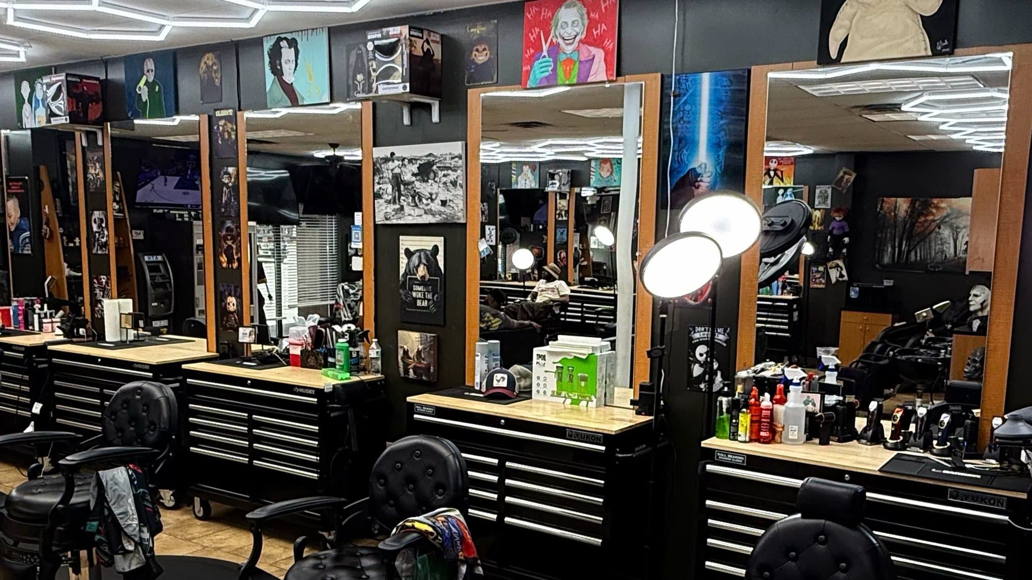 Phantom Fades cutting stations with black tufted chairs and ring lights under the hexagon LED ceiling.